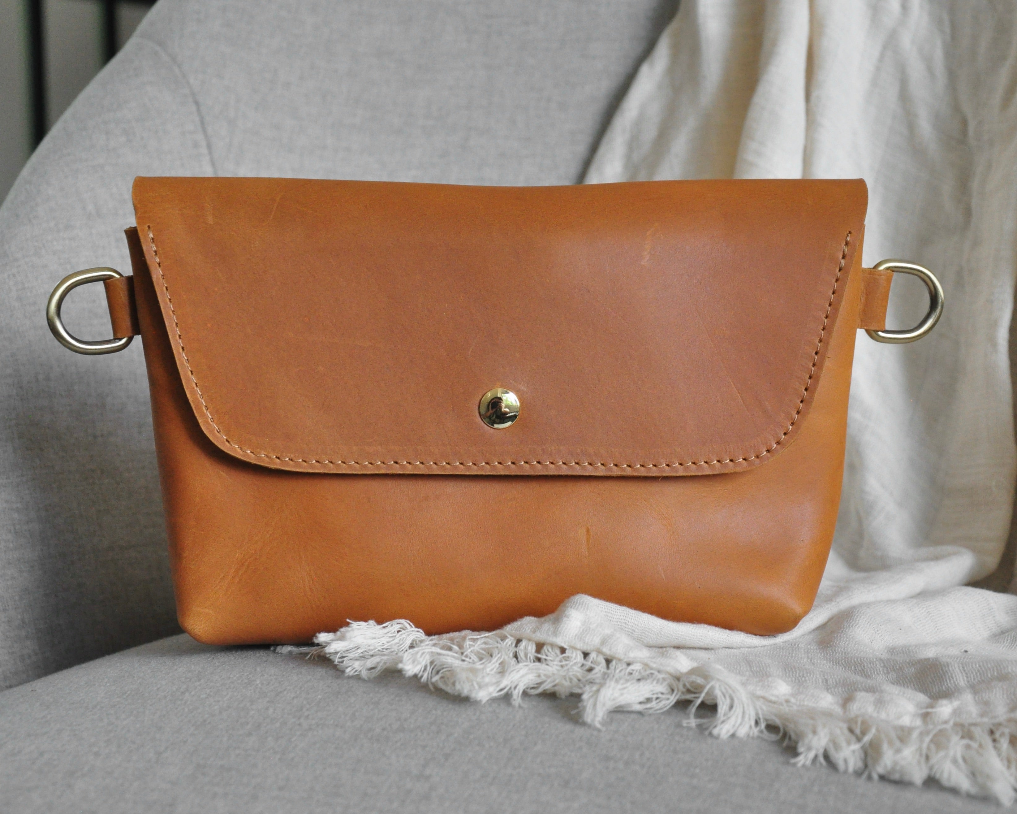 Crossbody Fanny Pack in tan handmade from high-quality genuine leather with adjustable strap, brass hardware, and magnetic closure. Full-grain leather Belt Bag with pocket for phone.