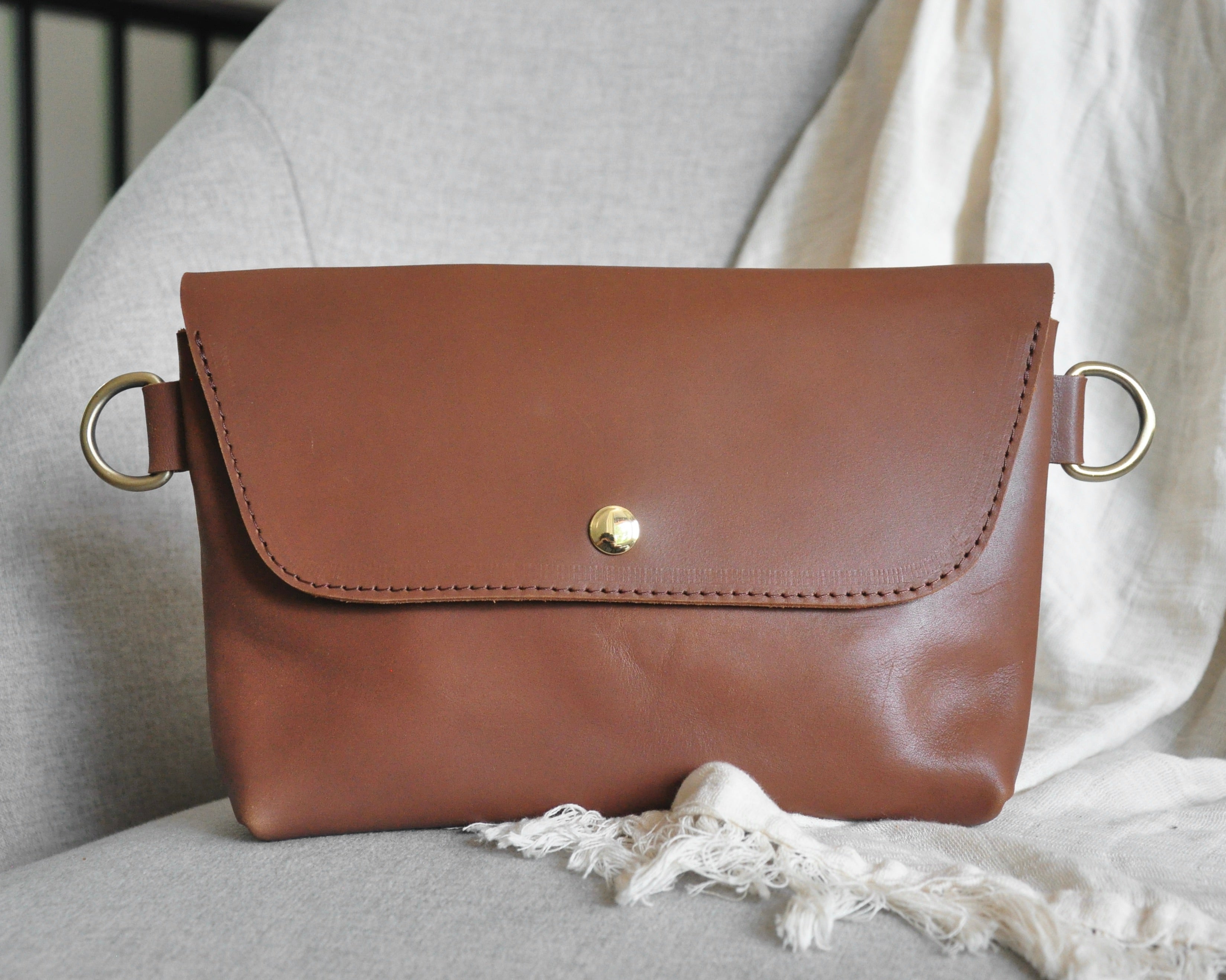 Crossbody Fanny Pack in brown handmade from high-quality genuine leather with adjustable strap, brass hardware, and magnetic closure. Full-grain leather Belt Bag with pocket for phone.