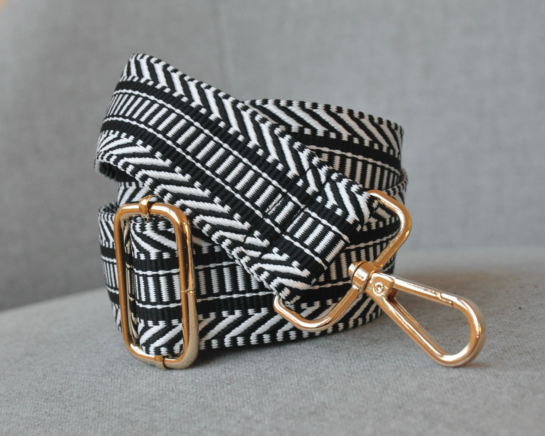 Patterned adjustable crossbody strap in neutral colors (tan, gray, and black) with gold hardware, perfect for customizing any purse or bag