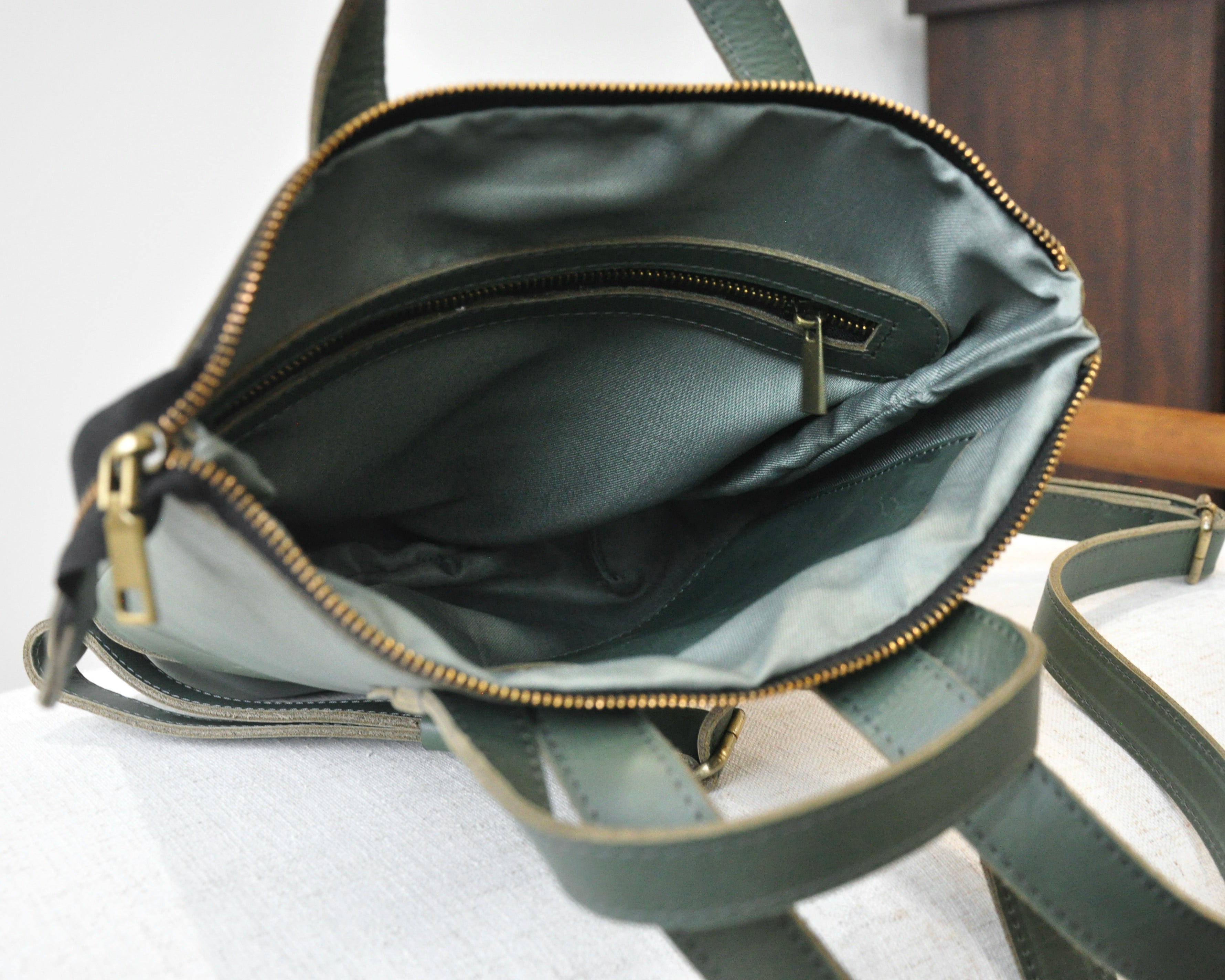 Small, olive green, genuine full-grain leather backpack for women with zipper, durable and handmade in Ethiopia