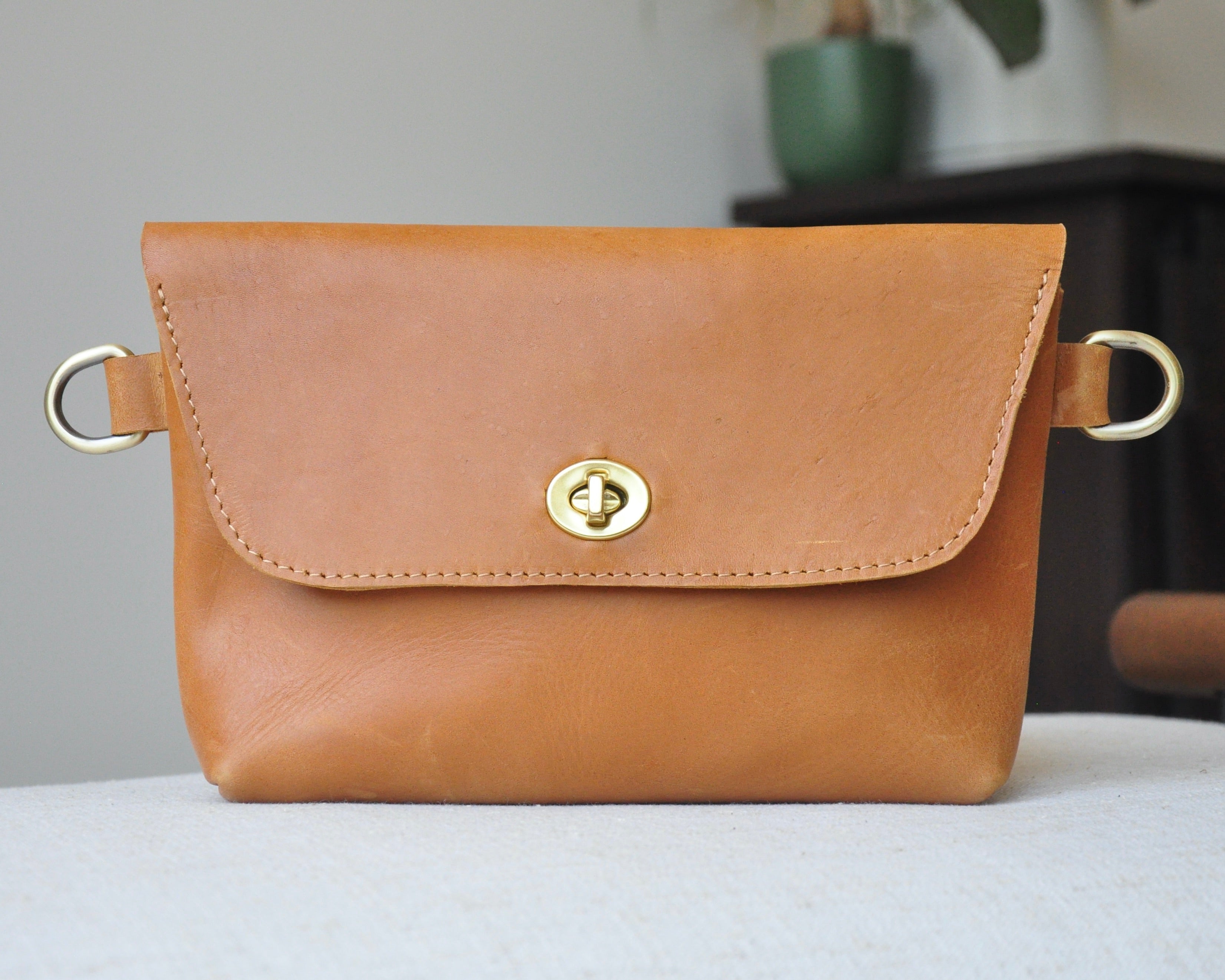 Crossbody Fanny Pack in tan handmade from high-quality genuine leather with adjustable strap, brass hardware, and twist lock closure. Full-grain leather Belt Bag with pocket for phone.