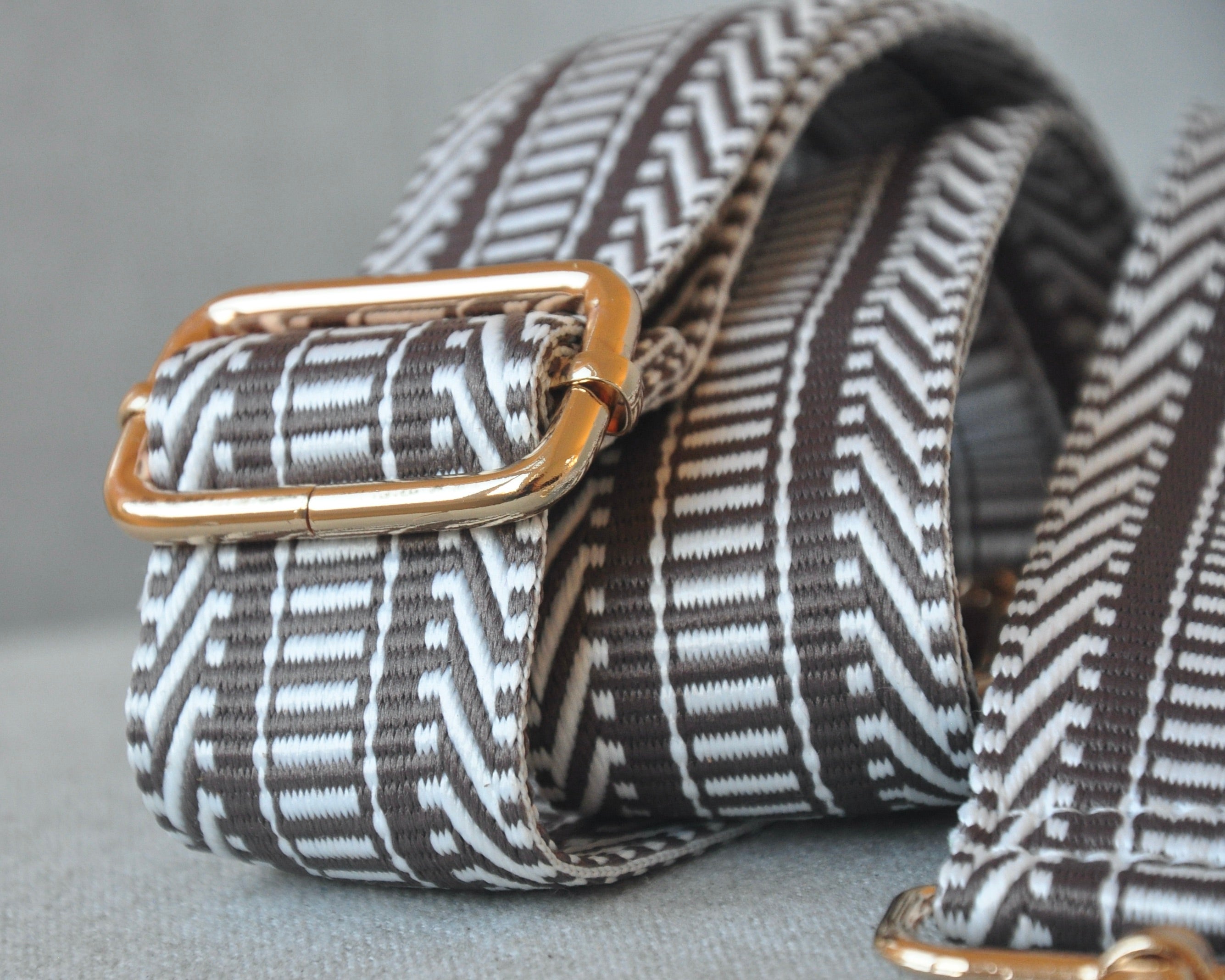 Patterned adjustable crossbody strap in neutral colors (tan, gray, and black) with gold hardware, perfect for customizing any purse or bag
