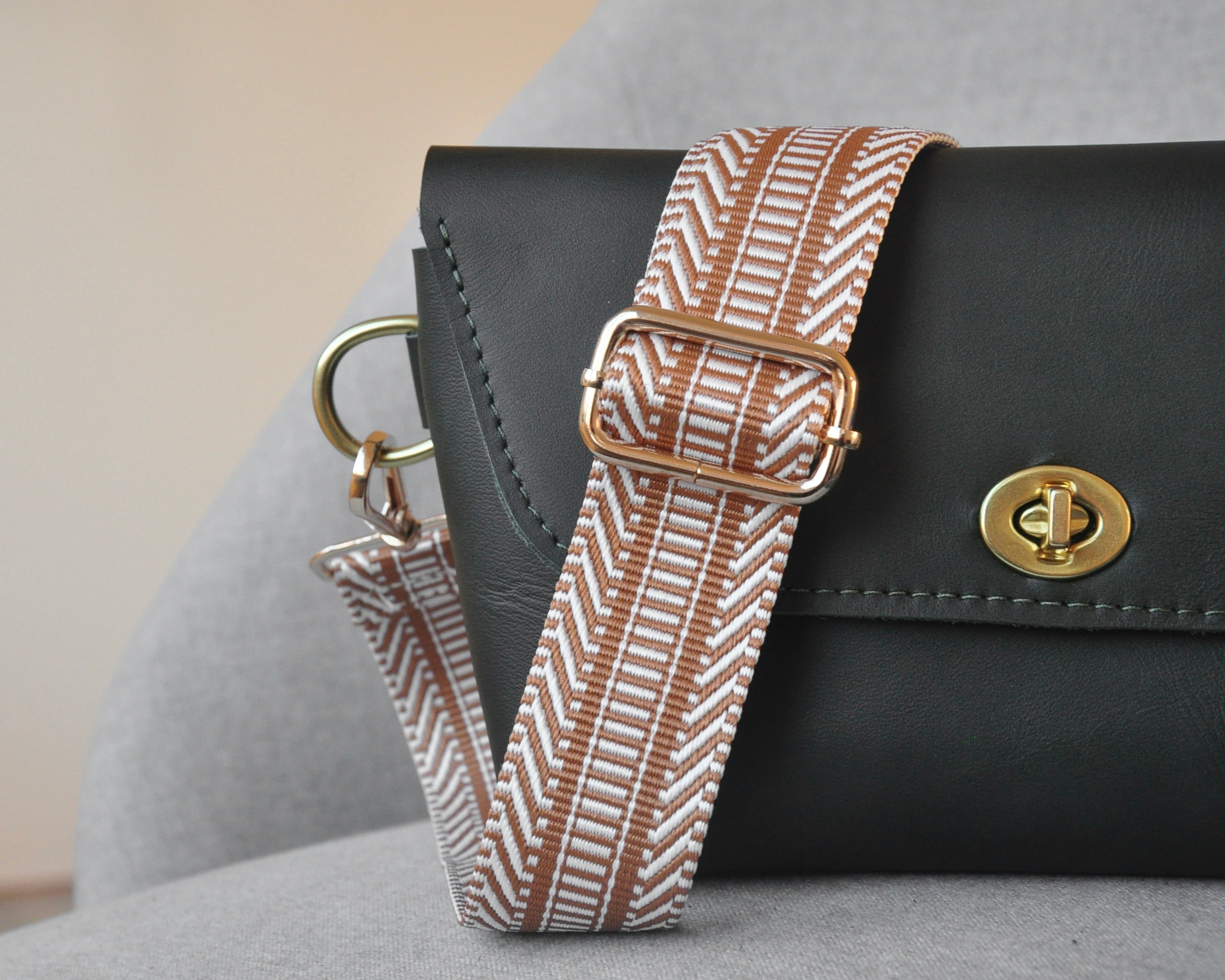 Patterned adjustable crossbody strap in neutral colors (tan, gray, and black) with gold hardware, perfect for customizing any purse or bag