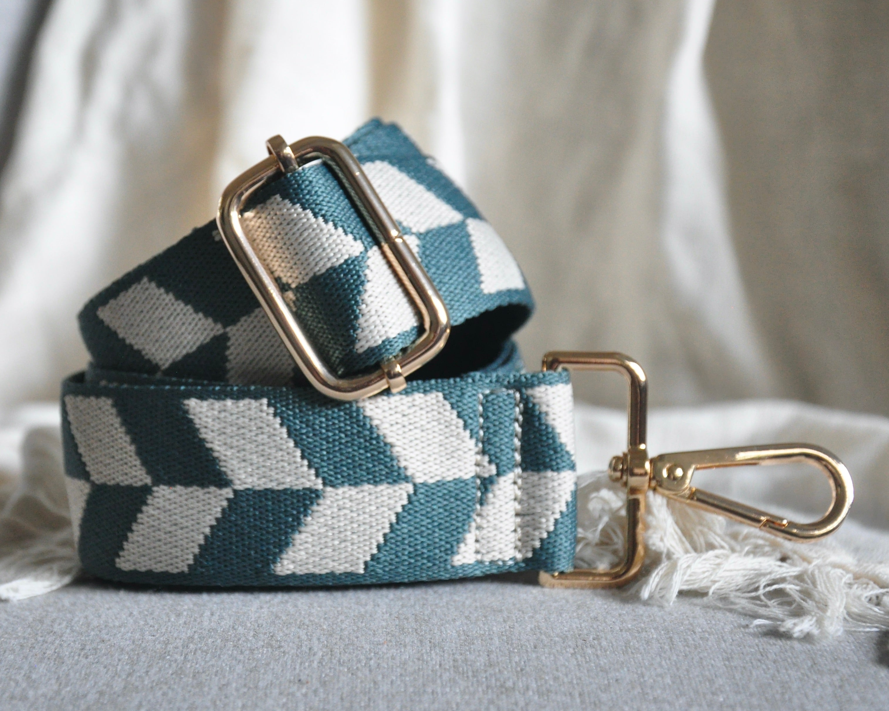 Geometric patterned adjustable crossbody strap in vibrant colors (orange, red, and blue) with gold hardware, perfect for customizing any purse or bag