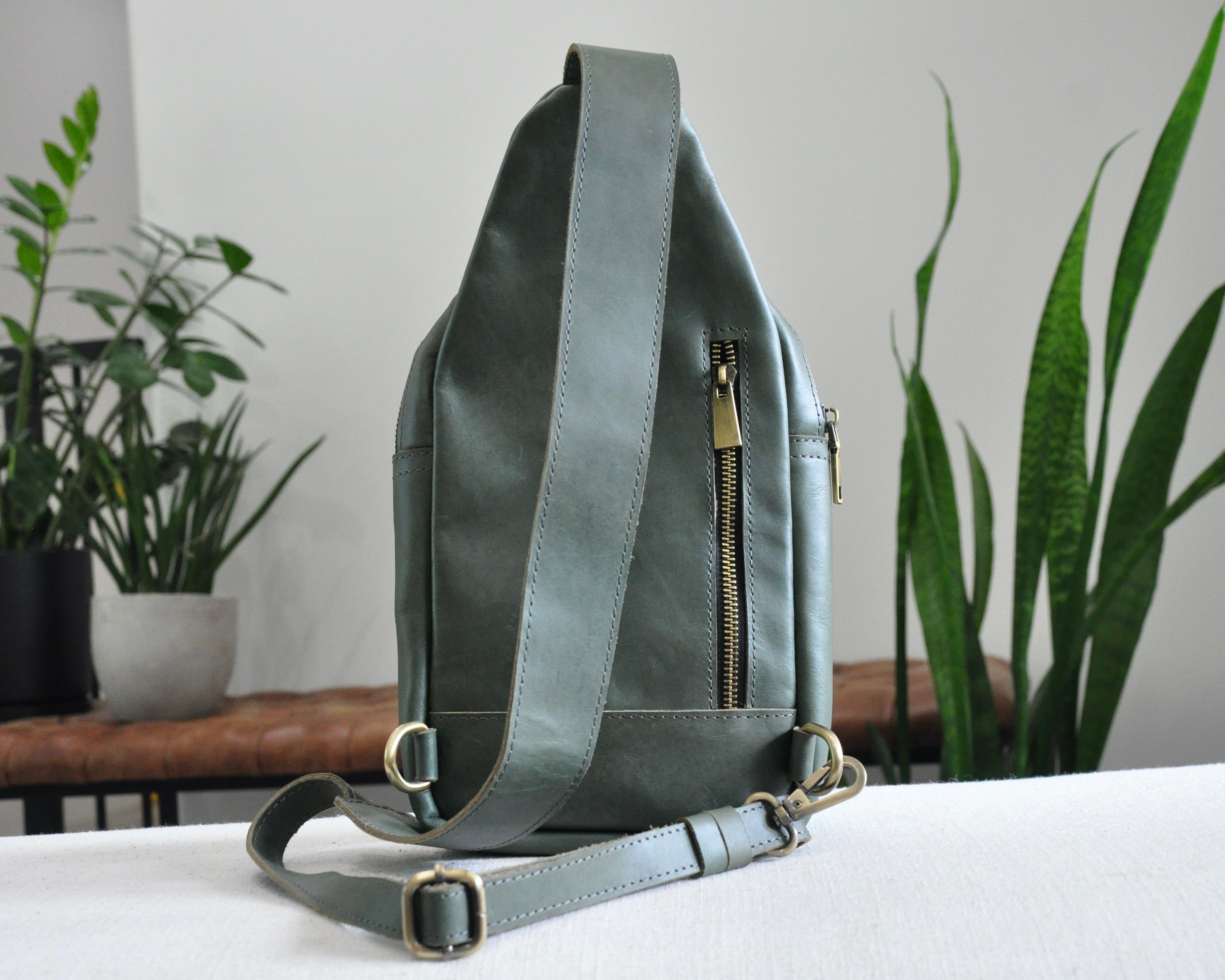 Full Grain genuine leather sling bag with adjustable strap and unisex design ethically and sustainably handmade in ethiopia in brown, tan, and olive green