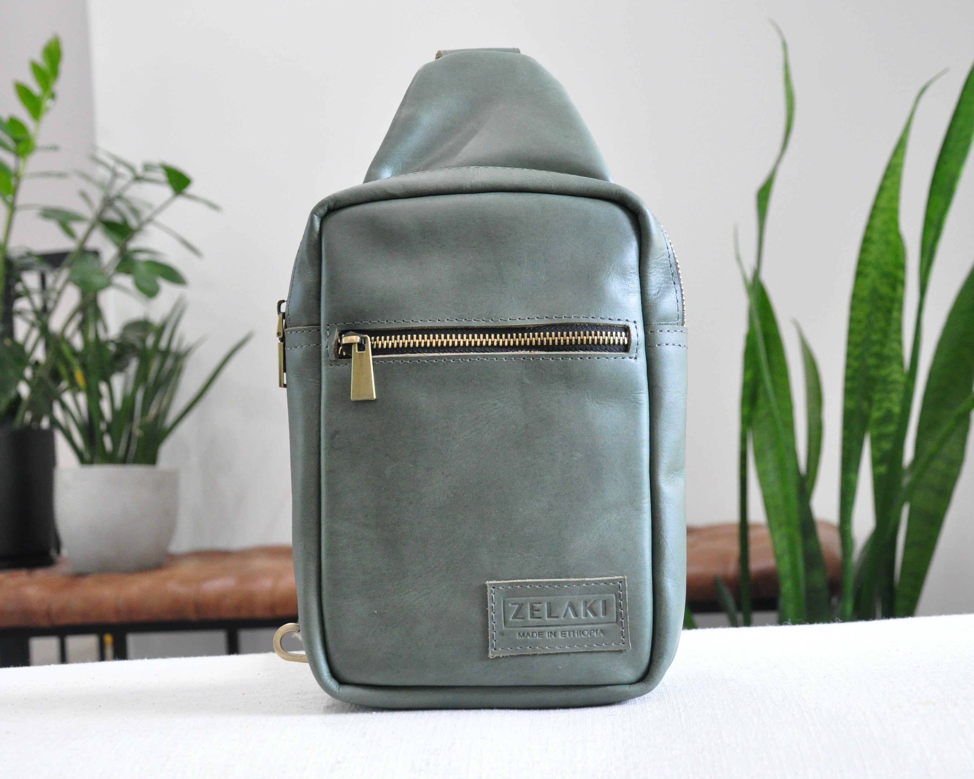 Full Grain genuine leather sling bag with adjustable strap and unisex design ethically and sustainably handmade in ethiopia in brown, tan, and olive green