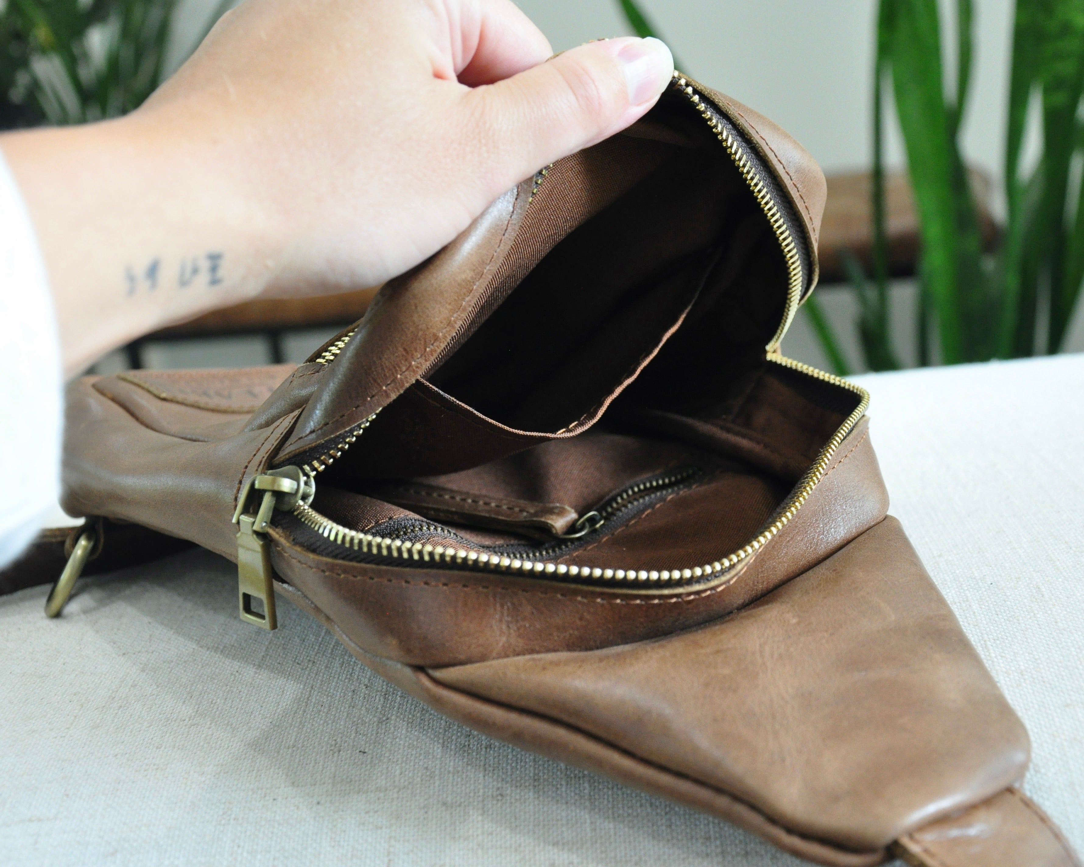 Full Grain genuine leather sling bag with adjustable strap and unisex design ethically and sustainably handmade in ethiopia in brown, tan, and olive green