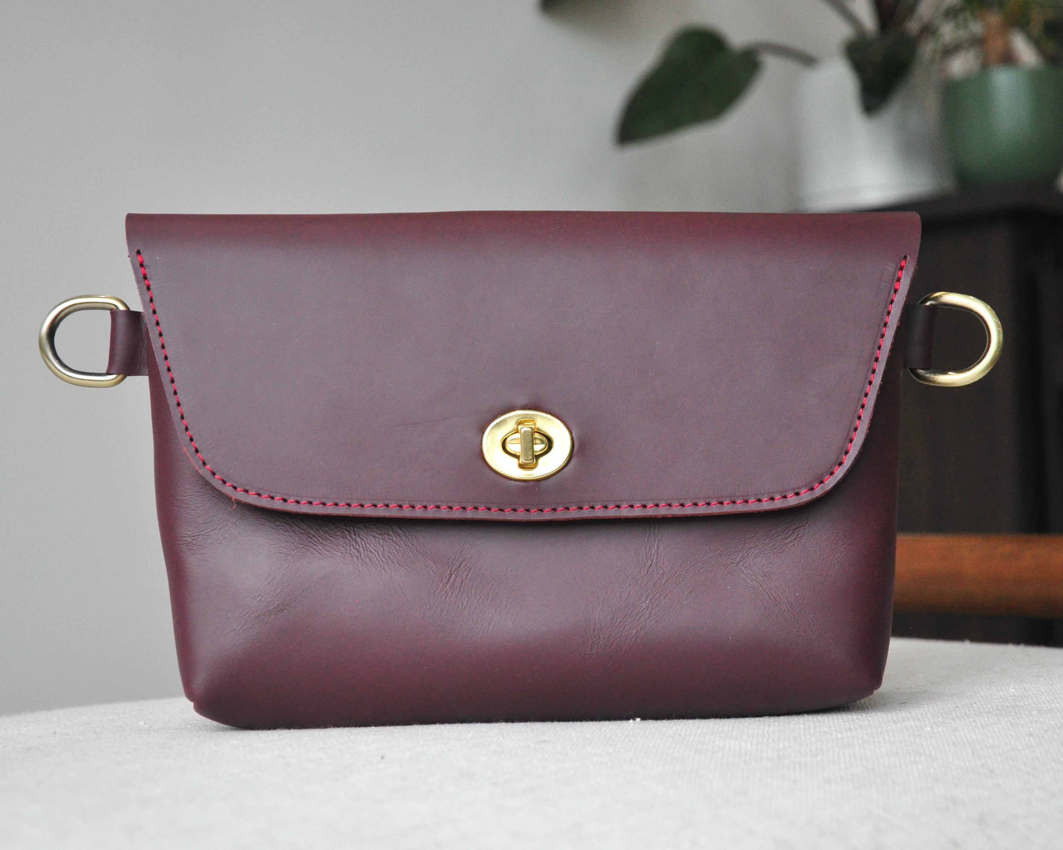 Crossbody Fanny Pack in burgundy handmade from high-quality genuine leather with adjustable strap, brass hardware, and twist lock closure. Full-grain leather Belt Bag with pocket for phone.