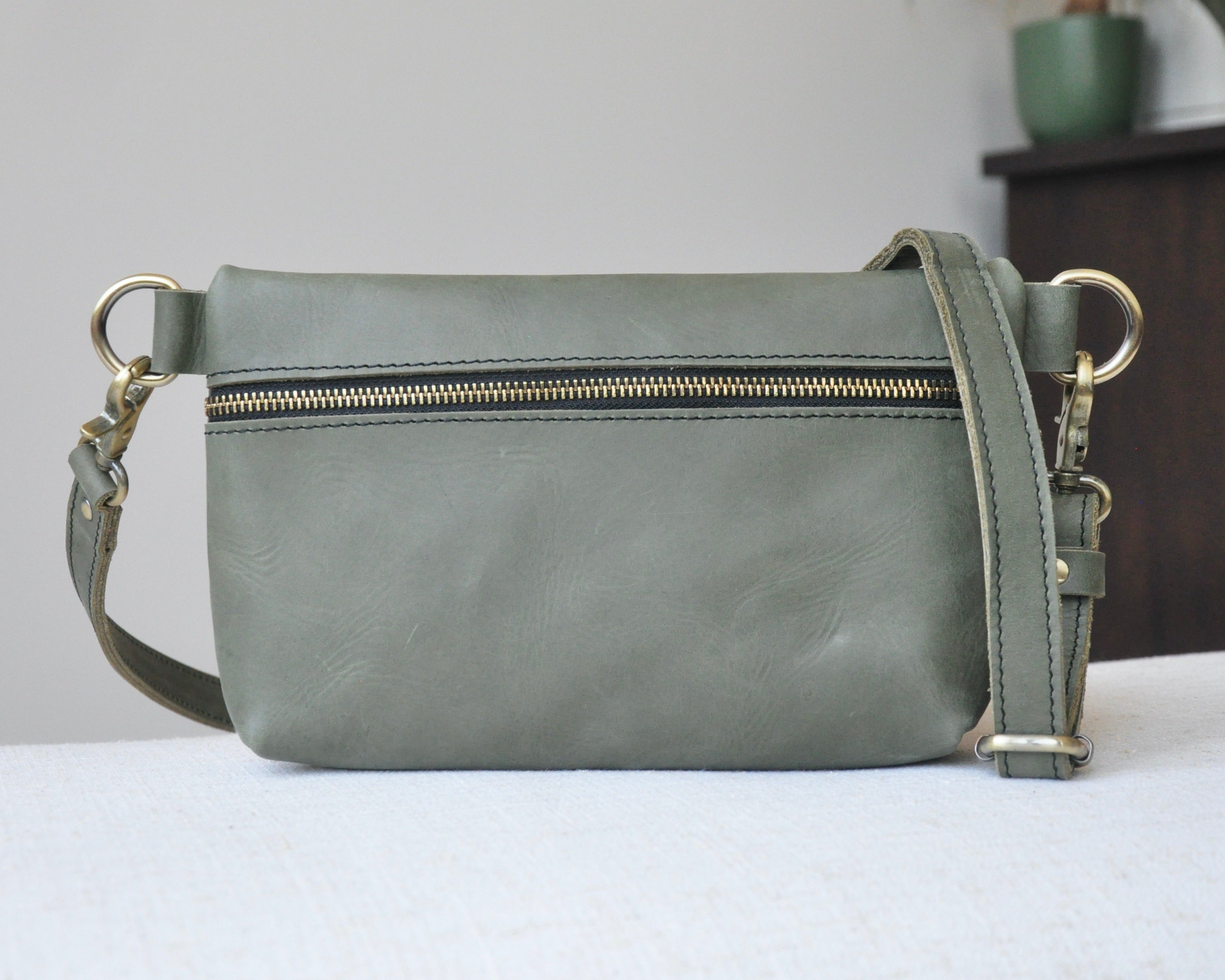 Crossbody Fanny Pack in olive green handmade from high-quality genuine leather with adjustable strap, brass hardware, and zipper closure. Full-grain leather Belt Bag with pocket for phone