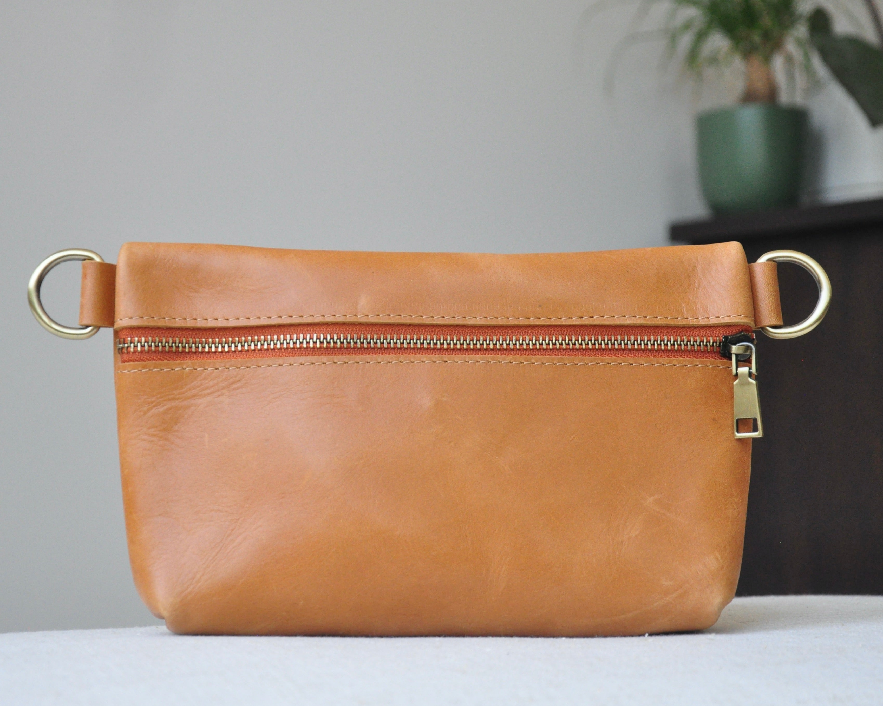 Crossbody Fanny Pack in tan handmade from high-quality genuine leather with adjustable strap, brass hardware, and zipper closure. Full-grain leather Belt Bag with pocket for phone