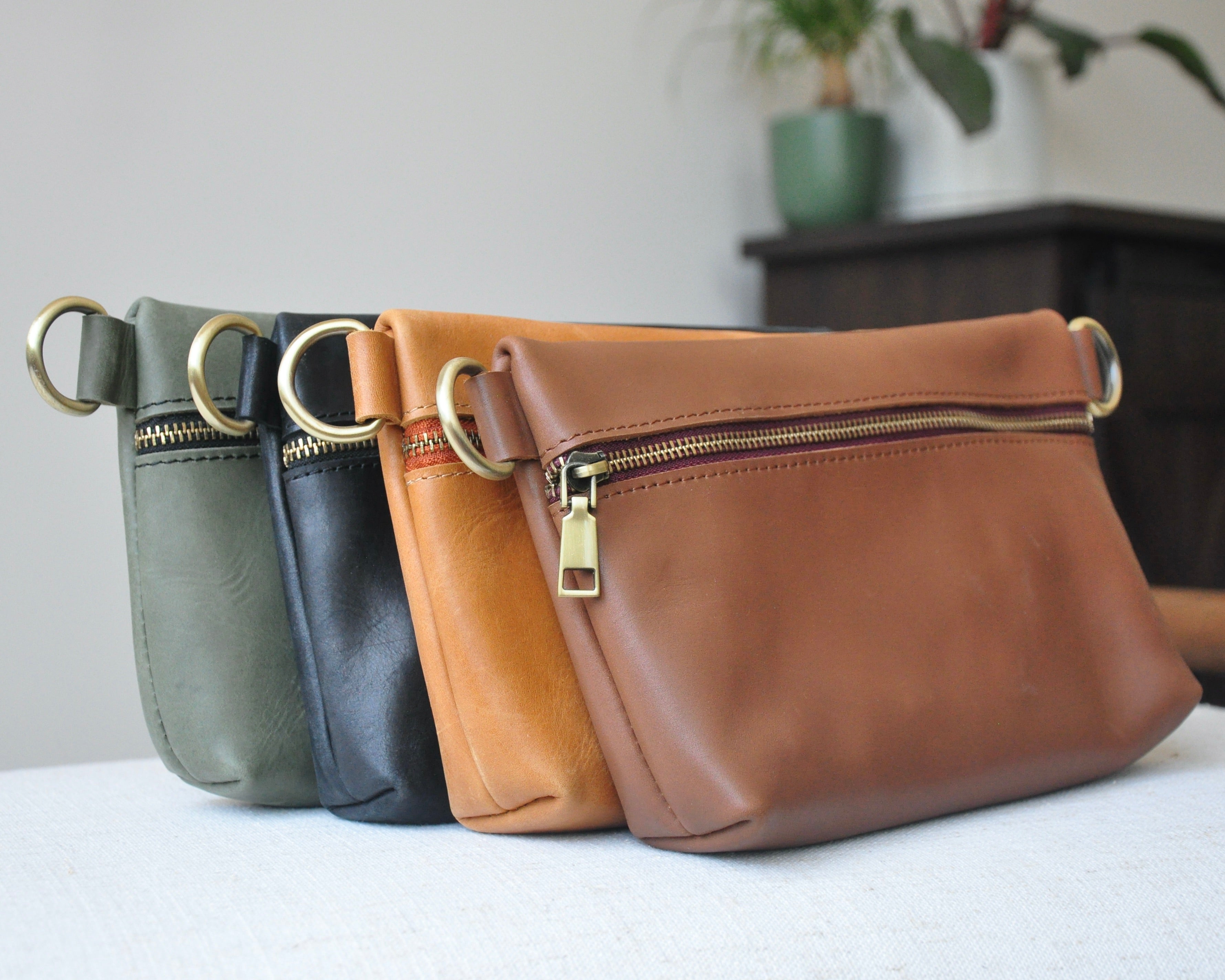 Crossbody Fanny Pack in black, olive, tan, and brown handmade from high-quality genuine leather with adjustable strap, brass hardware, and zipper closure. Full-grain leather Belt Bag.
