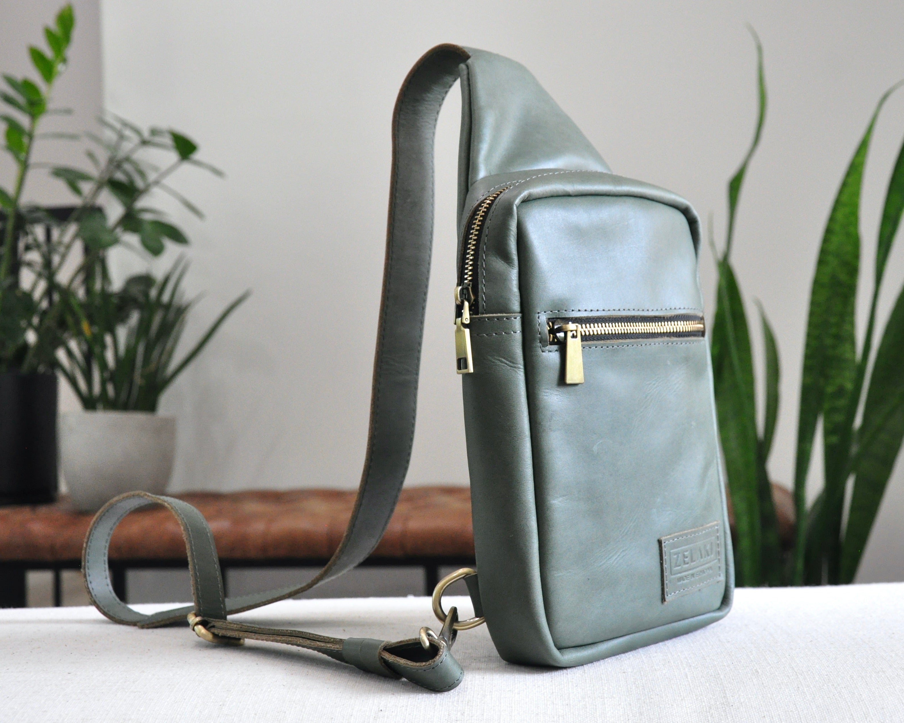 Full Grain genuine leather sling bag with adjustable strap and unisex design ethically and sustainably handmade in ethiopia in brown, tan, and olive green